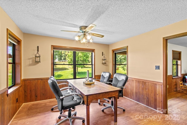 144 J And W Rd, Olin, NC 28660 - office featuring a wainscoted wall, wooden walls, light wood-type flooring, a ceiling fan, and a textured ceiling