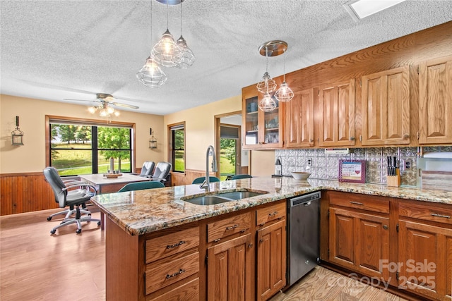 144 J And W Rd, Olin, NC 28660 - kitchen featuring dishwasher, wainscoting, a peninsula, a desk, and brown cabinetry