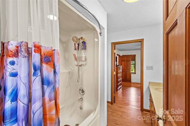 144 J And W Rd, Olin, NC 28660 - bathroom with wood finished floors, shower / bathtub combination with curtain, vanity, and a textured ceiling