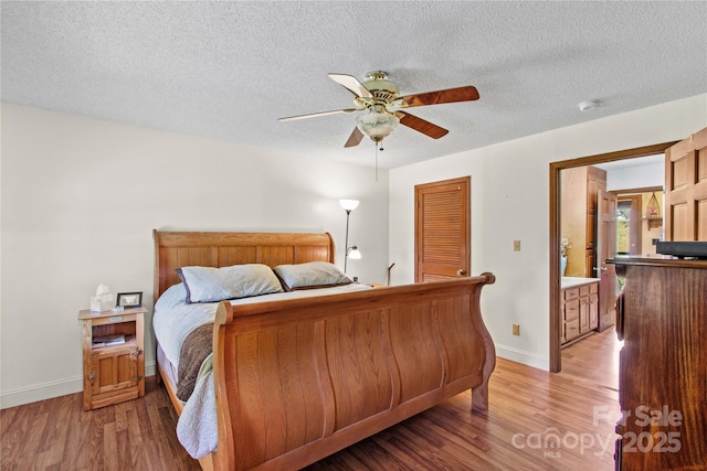 144 J And W Rd, Olin, NC 28660 - bedroom featuring a textured ceiling, light wood finished floors, a ceiling fan, and a closet