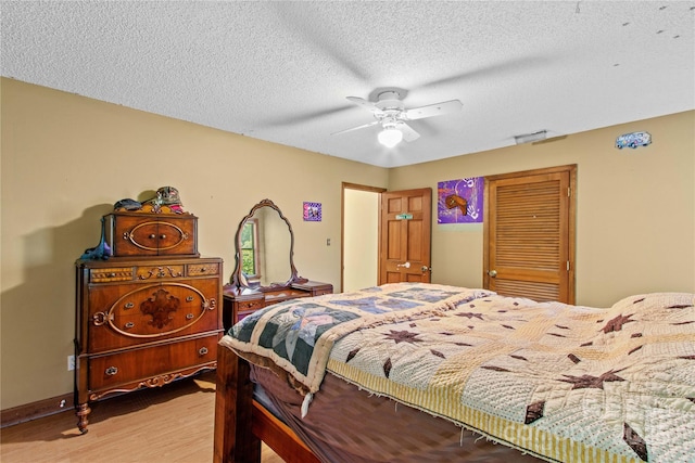 144 J And W Rd, Olin, NC 28660 - bedroom featuring light wood-style floors, ceiling fan, and a textured ceiling