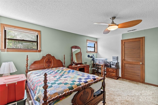 144 J And W Rd, Olin, NC 28660 - carpeted bedroom with a textured ceiling and a ceiling fan
