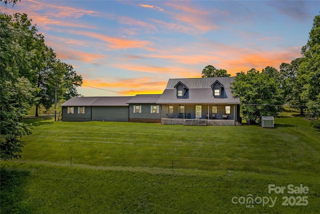 144 J And W Rd, Olin, NC 28660 - view of front of house with a porch, a yard, and a metal roof