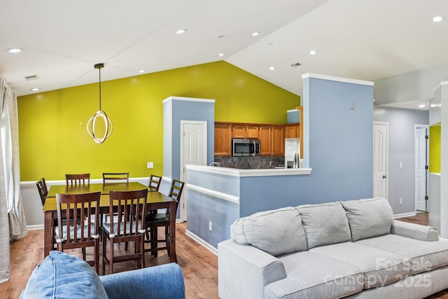 16009 Stuarts Draft Ct, Charlotte, NC 28278 - living room featuring light wood-type flooring and vaulted ceiling