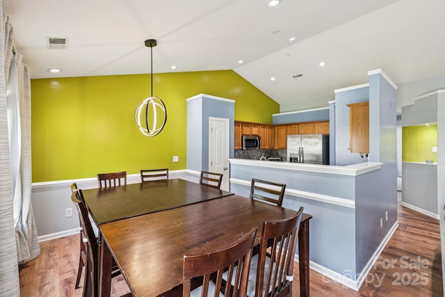 16009 Stuarts Draft Ct, Charlotte, NC 28278 - dining room with light wood-style floors and high vaulted ceiling