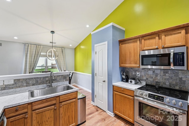 16009 Stuarts Draft Ct, Charlotte, NC 28278 - kitchen with stainless steel appliances, backsplash, lofted ceiling, brown cabinets, and light wood-style floors