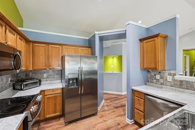 16009 Stuarts Draft Ct, Charlotte, NC 28278 - kitchen with stainless steel appliances, backsplash, brown cabinetry, and light wood-type flooring