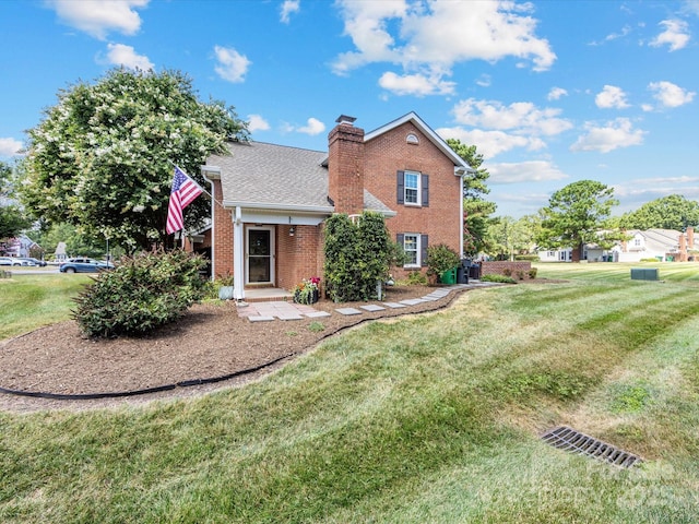 9237 N Vicksburg Park Ct, Charlotte, NC 28210 - view of front facade with a front yard, brick siding, a chimney, and roof with shingles