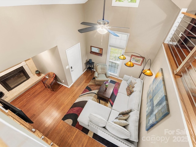 9237 N Vicksburg Park Ct, Charlotte, NC 28210 - living area with a towering ceiling, wood finished floors, and a ceiling fan