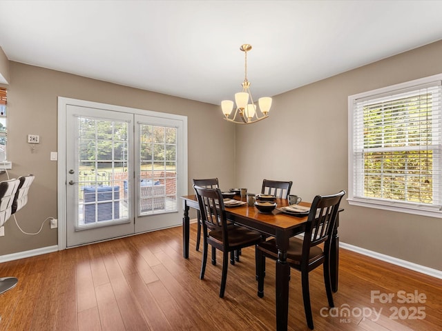9237 N Vicksburg Park Ct, Charlotte, NC 28210 - dining area with healthy amount of natural light, a chandelier, and wood finished floors
