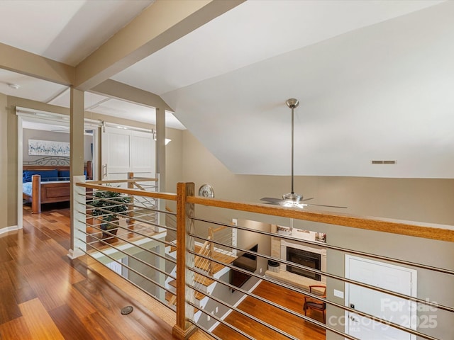 9237 N Vicksburg Park Ct, Charlotte, NC 28210 - hall with wood finished floors, vaulted ceiling, and an upstairs landing