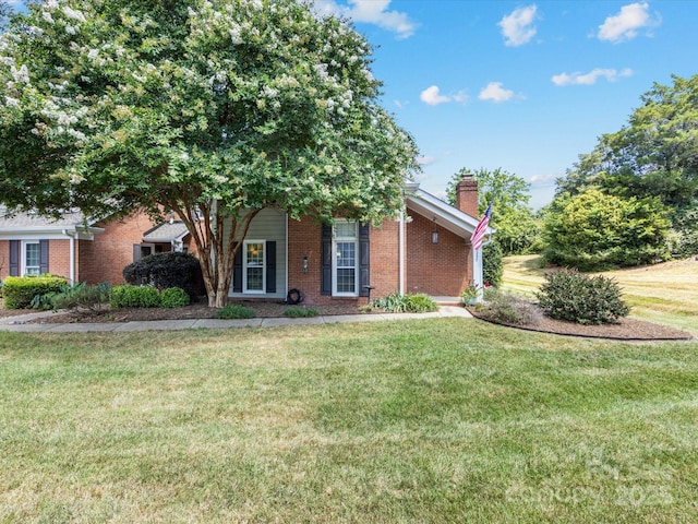 9237 N Vicksburg Park Ct, Charlotte, NC 28210 - obstructed view of property with a chimney, a front yard, and brick siding