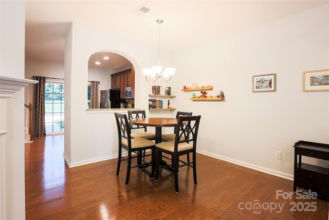 141 Leyton Loop Unit B, Mooresville, NC 28117 - dining space featuring a chandelier, dark wood finished floors, arched walkways, and recessed lighting
