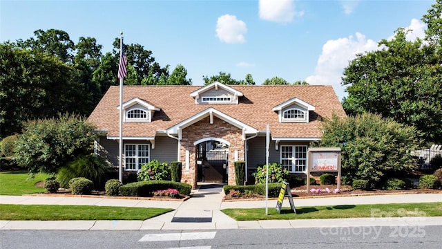 141 Leyton Loop Unit B, Mooresville, NC 28117 - view of front facade with stone siding, roof with shingles, a gate, and a front lawn