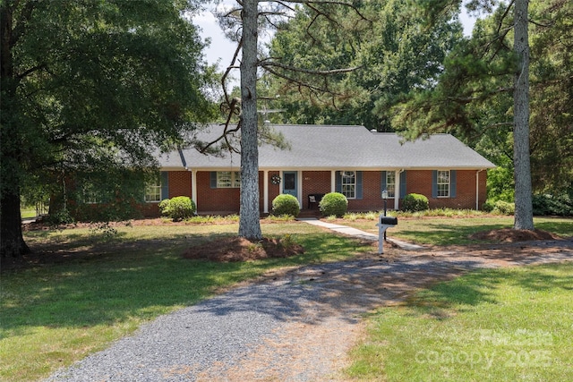 621 Big Lick Rd, Oakboro, NC 28129 - ranch-style house featuring gravel driveway, a front lawn, and brick siding
