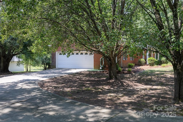 621 Big Lick Rd, Oakboro, NC 28129 - obstructed view of property featuring driveway, brick siding, and an attached garage