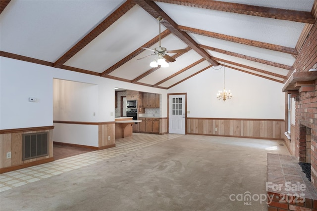 621 Big Lick Rd, Oakboro, NC 28129 - unfurnished living room featuring a brick fireplace, wainscoting, a ceiling fan, light carpet, and a chandelier