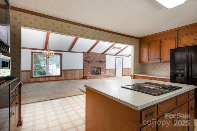 621 Big Lick Rd, Oakboro, NC 28129 - kitchen with electric cooktop, wallpapered walls, light flooring, a wainscoted wall, and healthy amount of natural light