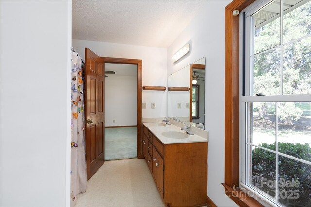 621 Big Lick Rd, Oakboro, NC 28129 - full bath featuring double vanity, healthy amount of natural light, and a textured ceiling