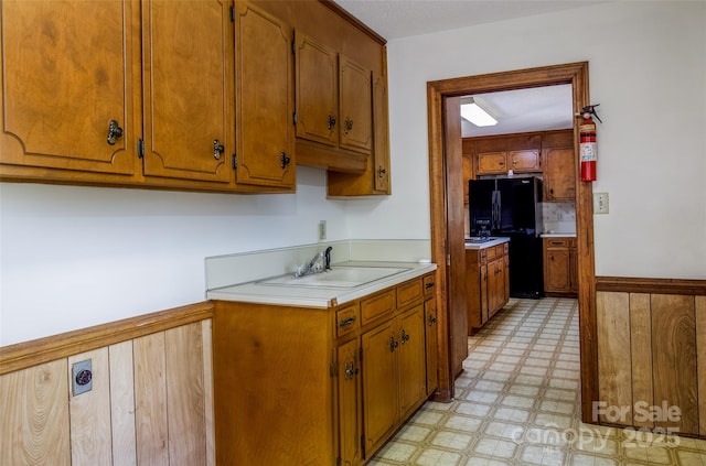 621 Big Lick Rd, Oakboro, NC 28129 - kitchen featuring freestanding refrigerator, light floors, light countertops, and brown cabinets