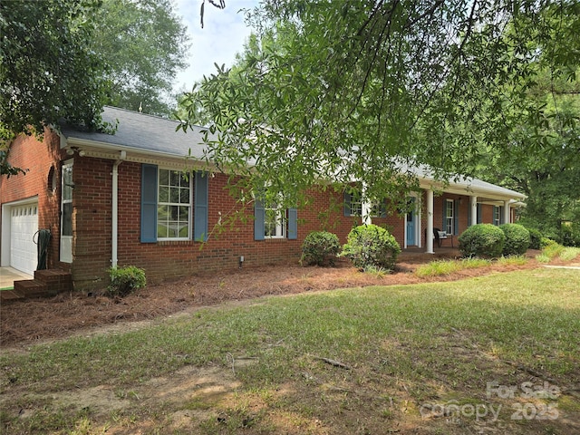 621 Big Lick Rd, Oakboro, NC 28129 - view of front of property featuring brick siding, a porch, a garage, a front yard, and a shingled roof