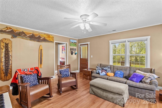 179 J And W Rd, Olin, NC 28660 - living area featuring a textured ceiling, ceiling fan, light wood-type flooring, and crown molding