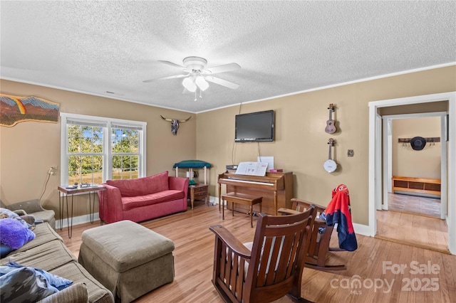 179 J And W Rd, Olin, NC 28660 - living room with ceiling fan, wood finished floors, a textured ceiling, and crown molding