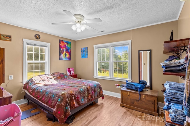 179 J And W Rd, Olin, NC 28660 - bedroom with wood finished floors, a textured ceiling, and a ceiling fan