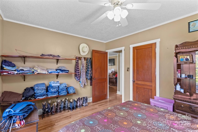 179 J And W Rd, Olin, NC 28660 - bedroom featuring a textured ceiling, wood finished floors, crown molding, and a ceiling fan
