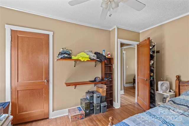 179 J And W Rd, Olin, NC 28660 - bedroom with wood finished floors, a textured ceiling, a ceiling fan, and ornamental molding