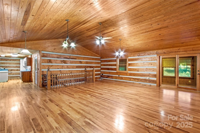 179 J And W Rd, Olin, NC 28660 - unfurnished living room with wood ceiling, rustic walls, hardwood / wood-style floors, vaulted ceiling, and ceiling fan