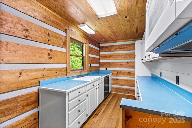 179 J And W Rd, Olin, NC 28660 - miscellaneous room with wooden ceiling, wood walls, light wood-style floors, and wine cooler