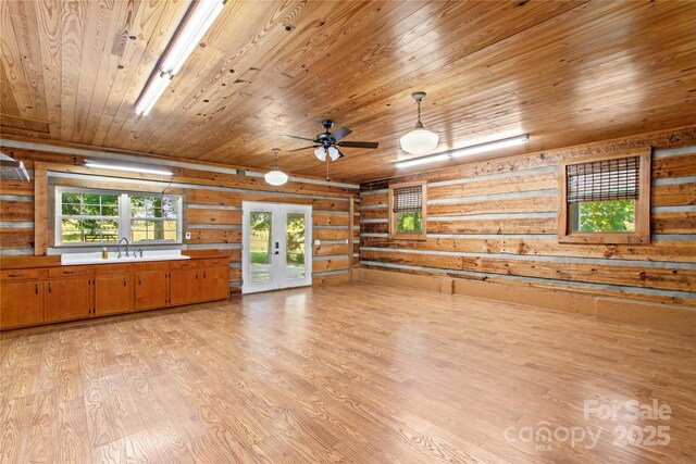 179 J And W Rd, Olin, NC 28660 - unfurnished living room featuring rustic walls, wooden ceiling, light wood finished floors, french doors, and a ceiling fan