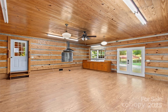 179 J And W Rd, Olin, NC 28660 - unfurnished living room with french doors, wooden ceiling, light wood-style floors, ceiling fan, and wooden walls