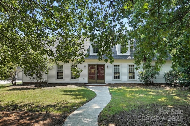 11100 Painted Tree Rd, Charlotte, NC 28226 - cape cod home featuring a front yard, a shingled roof, and french doors