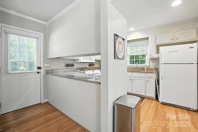 11100 Painted Tree Rd, Charlotte, NC 28226 - kitchen featuring white appliances, white cabinetry, ornamental molding, light stone countertops, and light wood finished floors