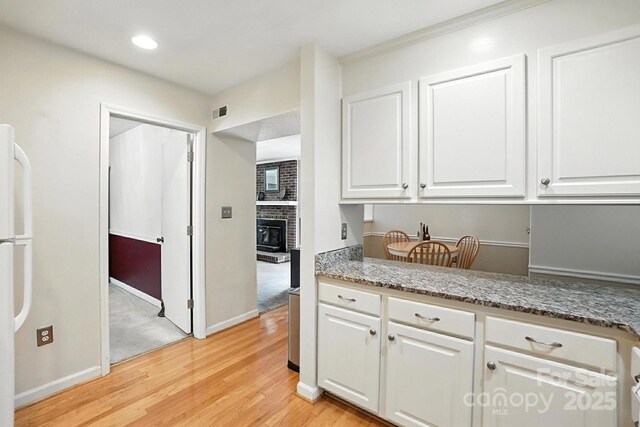 11100 Painted Tree Rd, Charlotte, NC 28226 - kitchen featuring freestanding refrigerator, white cabinets, light wood finished floors, light stone counters, and recessed lighting