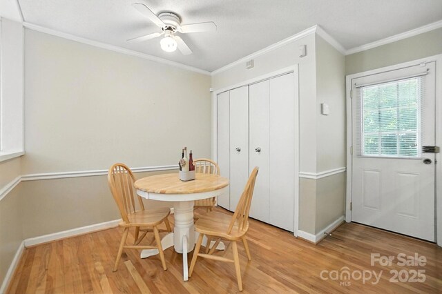 11100 Painted Tree Rd, Charlotte, NC 28226 - dining room featuring light wood finished floors, crown molding, and a ceiling fan