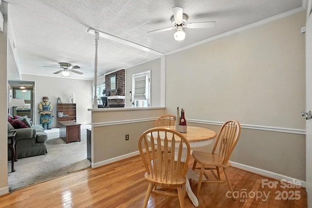 11100 Painted Tree Rd, Charlotte, NC 28226 - dining space with a ceiling fan, ornamental molding, light wood-style flooring, and a textured ceiling