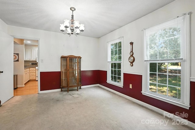 11100 Painted Tree Rd, Charlotte, NC 28226 - unfurnished dining area featuring a chandelier and baseboards