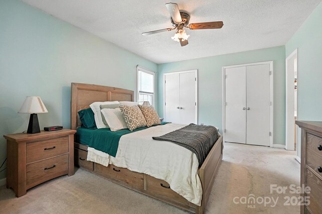 11100 Painted Tree Rd, Charlotte, NC 28226 - bedroom featuring light carpet, multiple closets, a textured ceiling, and ceiling fan