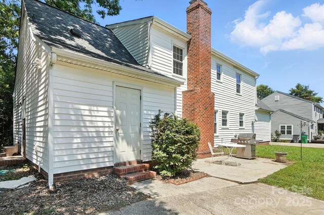11100 Painted Tree Rd, Charlotte, NC 28226 - back of property with entry steps, a chimney, a patio area, and roof with shingles