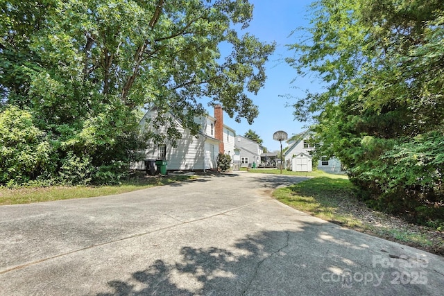 11100 Painted Tree Rd, Charlotte, NC 28226 - view of home's exterior with driveway and a chimney