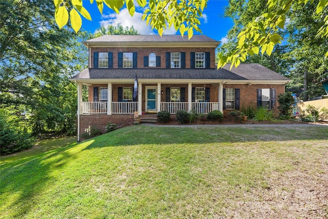 7410 Derby Meadows Ct, Charlotte, NC 28216 - view of front of house with brick siding, a front lawn, and covered porch