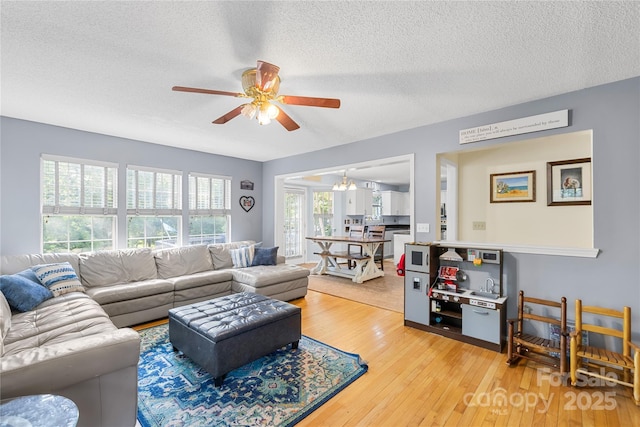 7410 Derby Meadows Ct, Charlotte, NC 28216 - living area featuring ceiling fan, a textured ceiling, and light wood finished floors