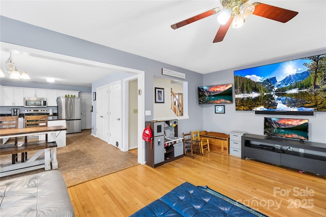 7410 Derby Meadows Ct, Charlotte, NC 28216 - living area featuring light wood finished floors and ceiling fan