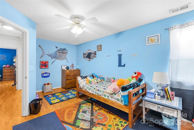 7410 Derby Meadows Ct, Charlotte, NC 28216 - bedroom featuring wood finished floors, a ceiling fan, and a textured ceiling