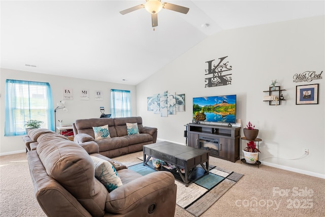 226 Caley St, Kings Mountain, NC 28086 - living room featuring light carpet, lofted ceiling, ceiling fan, healthy amount of natural light, and a glass covered fireplace