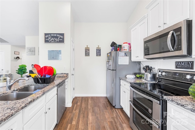 226 Caley St, Kings Mountain, NC 28086 - kitchen featuring appliances with stainless steel finishes, dark wood-style flooring, white cabinets, and light stone counters