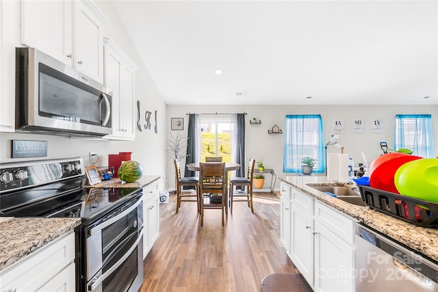 226 Caley St, Kings Mountain, NC 28086 - kitchen with stainless steel appliances, light wood finished floors, white cabinetry, recessed lighting, and light stone countertops